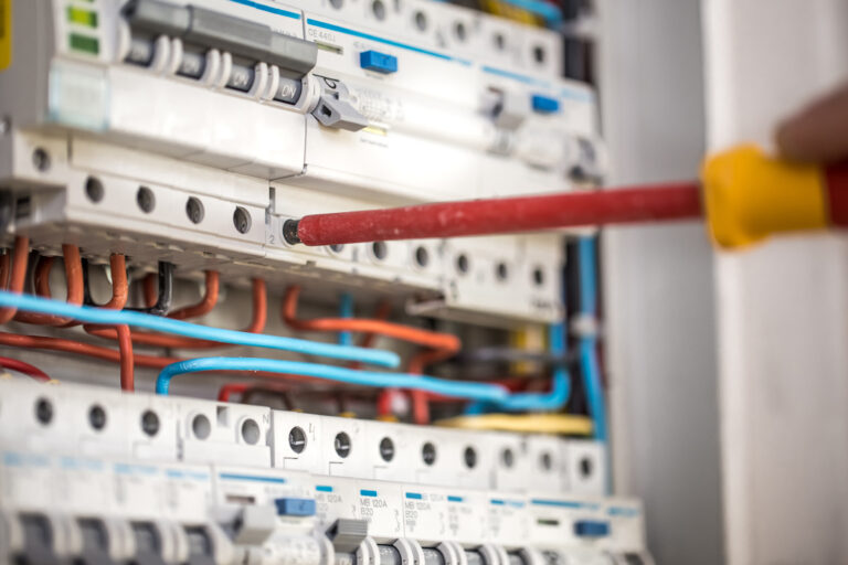 man-an-electrical-technician-working-in-a-switchb-2021-04-06-16-36-06-utc